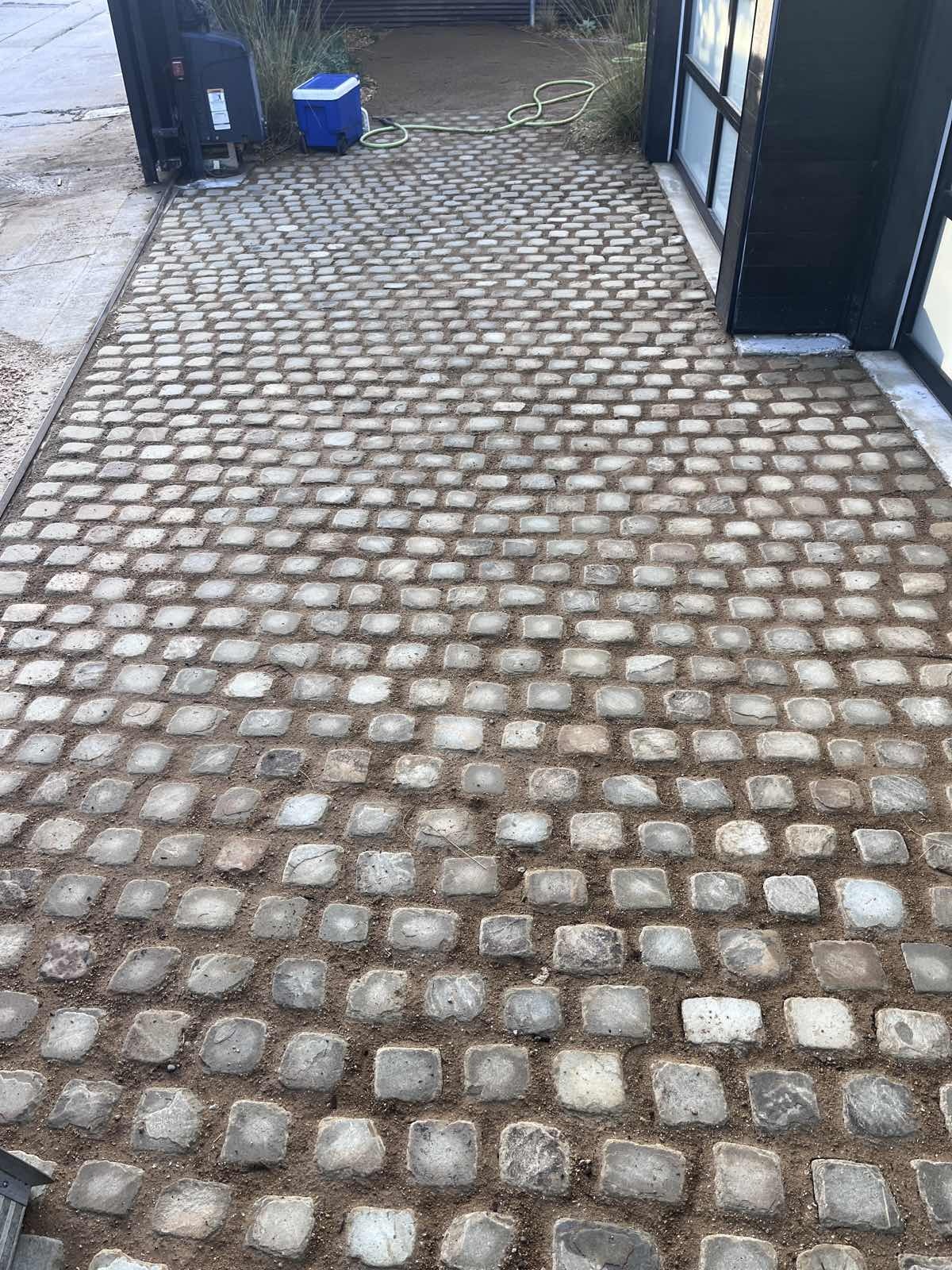 Cobblestone driveway border laid in the South Bay